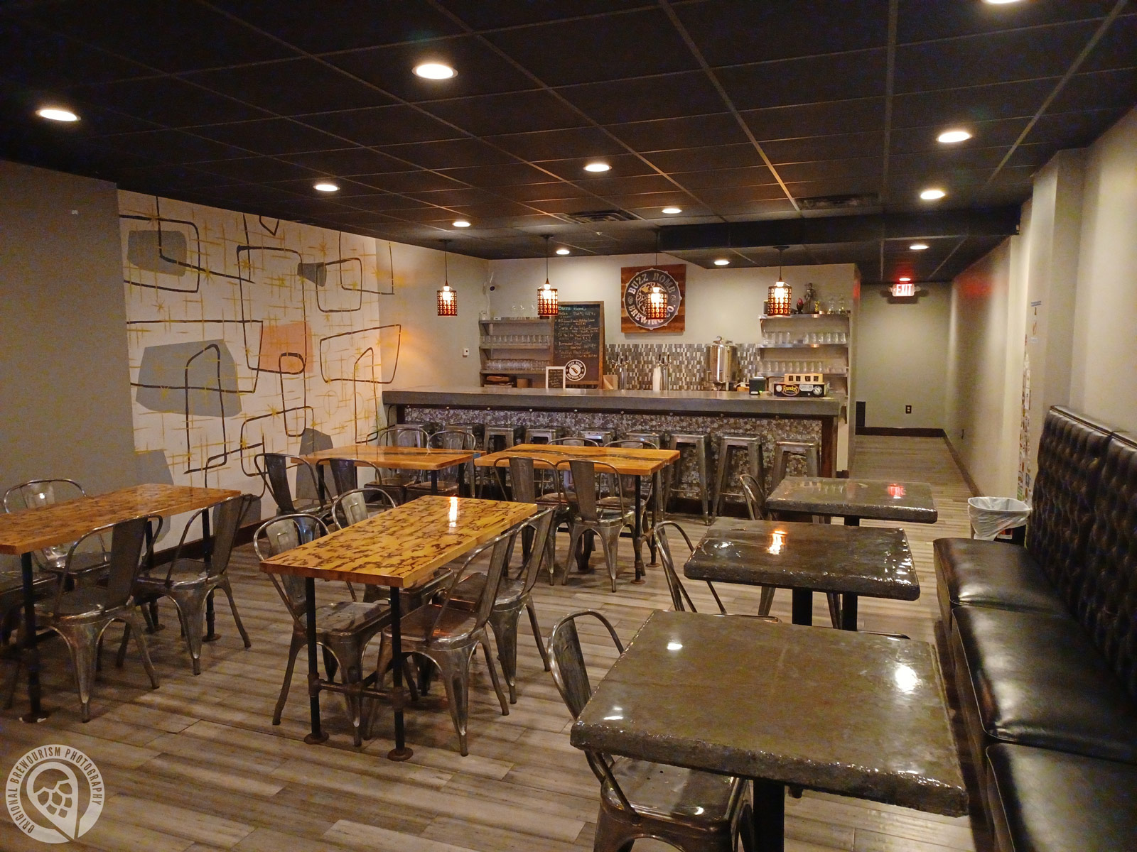upstairs seating area with bar and tables at Buzz Bomb Brewing